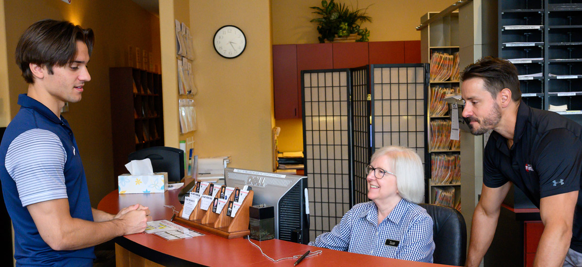 New patient speaking with receptionist at front desk