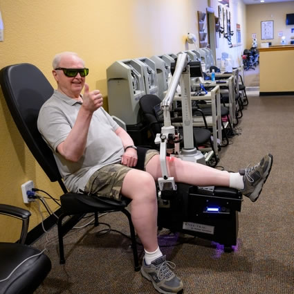 Patient receiving laser therapy on knee
