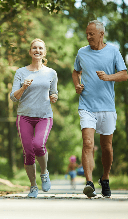 Happy elderly couple jogging