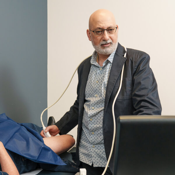 woman looking at varicose vein in leg