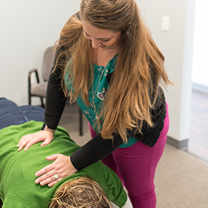Dr. Alyssa adjusting a patient's back