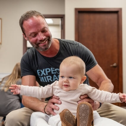 Dr Matt adjusting baby