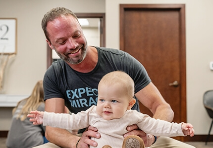 Dr Matt adjusting baby
