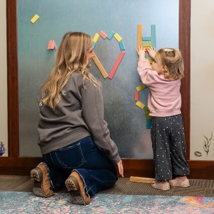 mom and kid playing in waiting area