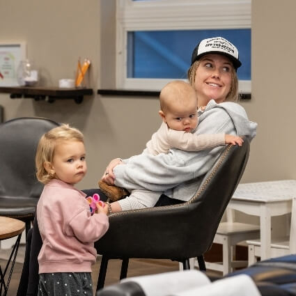 mom holding kids and smiling
