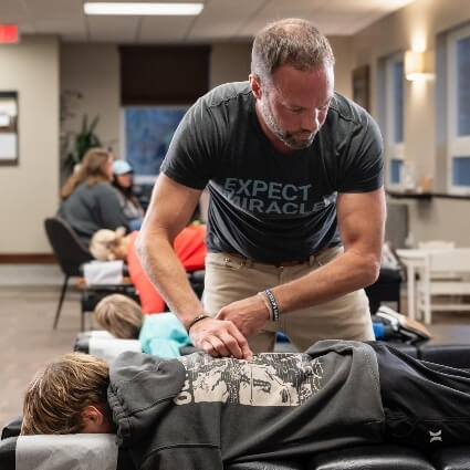 Dr Matt adjusting kid