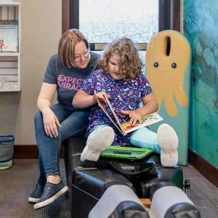 mom and team member reading a book