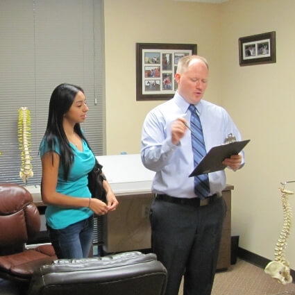 Dr Minogue talking with patient