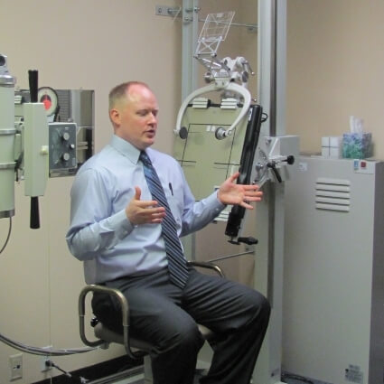 Dr Minogue showing patient machine