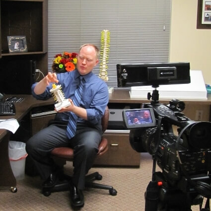 Dr Jason showing patient spine model