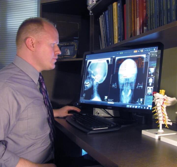 Houston chiropractor Dr. Jason checking X-ray