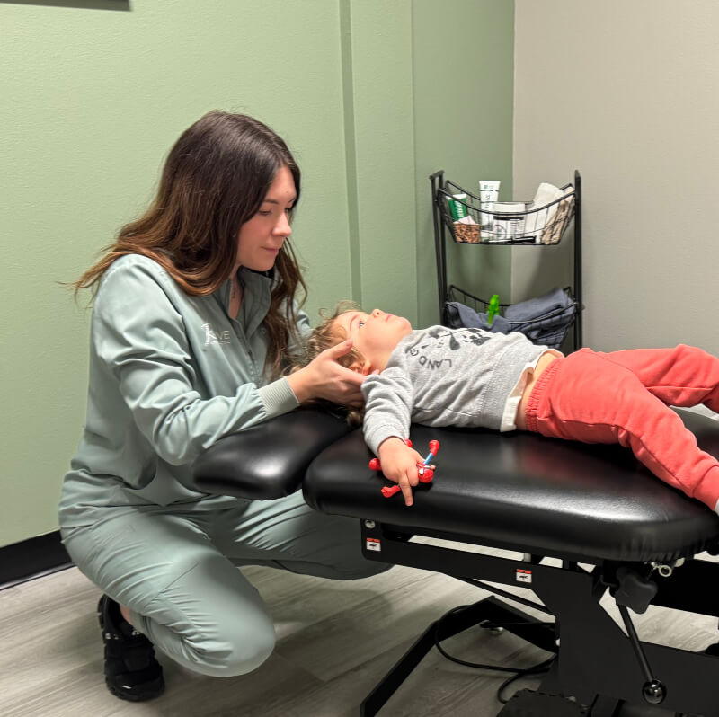 Grand Forks chiropractor Dr Nelson adjusting child patients neck