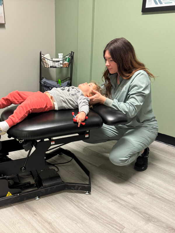 Dr. Nelson adjusting toddler