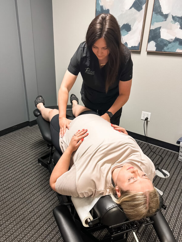 Chiropractor adjusting pregnant patient