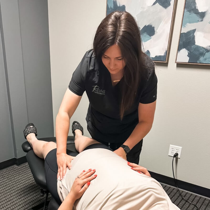 Revive Chiropractic patient having pregnant stomach examined