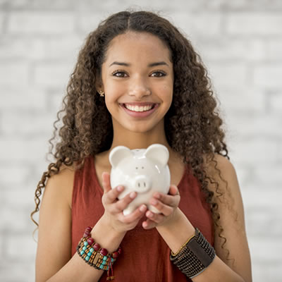 Young woman holding piggy bank