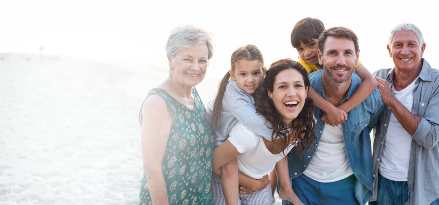family of three sitting in grass