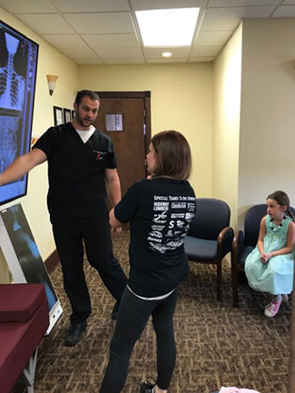 Dr. Ellensohn reviewing x-rays with a patient