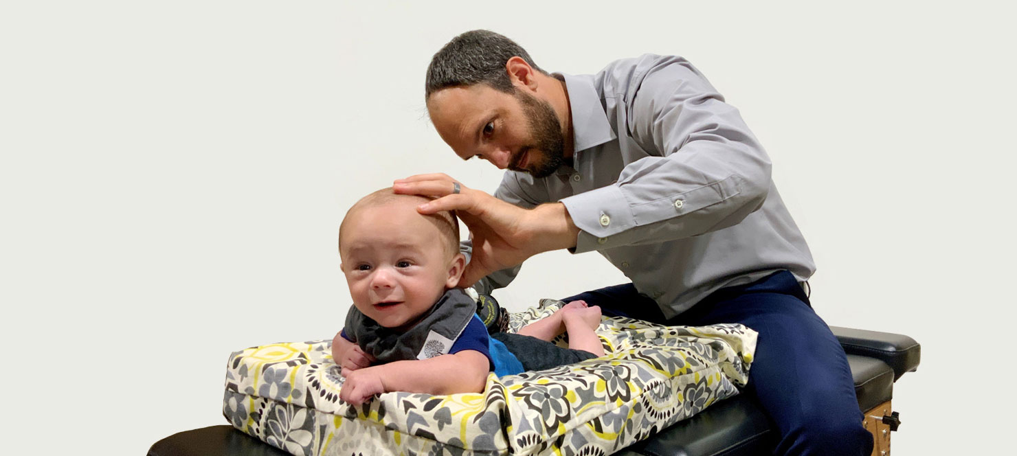 Dr Chris adjusting an infant patient