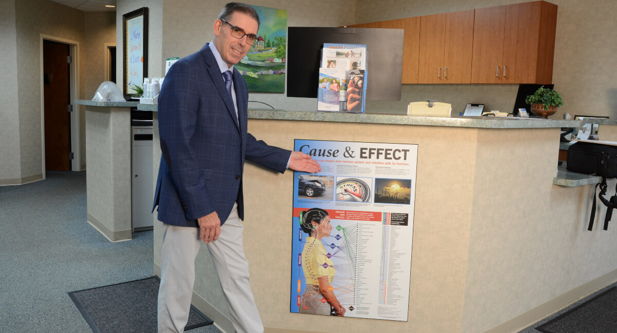 Greenville chiropractor standing at reception