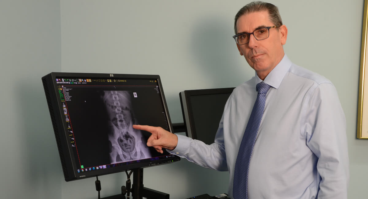 Chiropractor pointing at x-ray