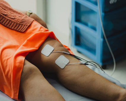 Female patient treated with Electrical Muscle Stimulation Therapy