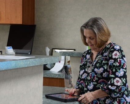 Senior patient checking in at O'Donahue Chiropractic