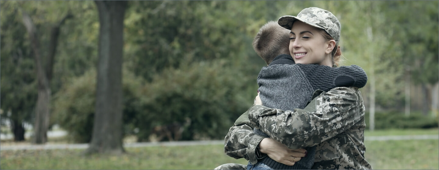 Military mom hugging her child