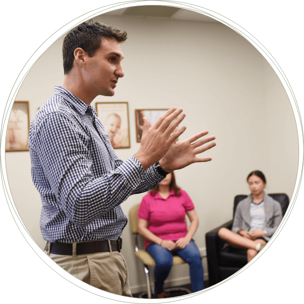 Dr Stott  of Abundant Life Chiropractic talking to patients