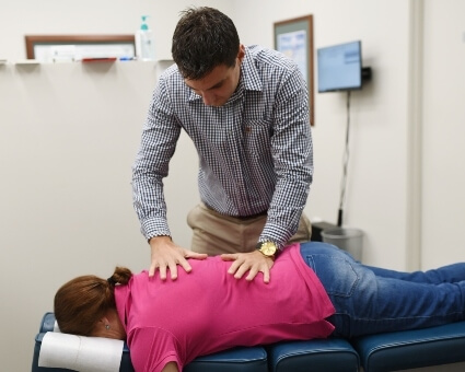 Patient wearing pink shirt gets adjusted