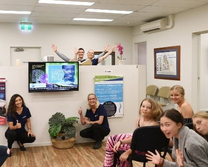 Patients and staff posing for silly photo in waiting area