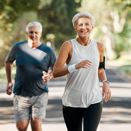 mature man and woman running outdoors