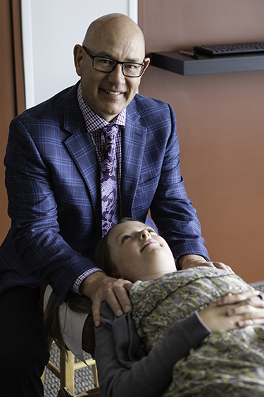 Dr. Derrick adjusting a child