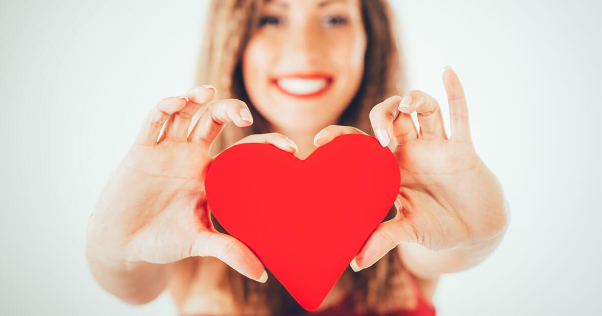 Woman holding paper heart.