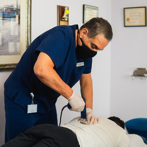 Dr Gerry adjusting patients back