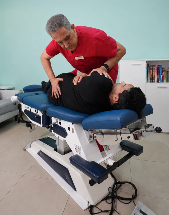 chiropractor adjusting patient