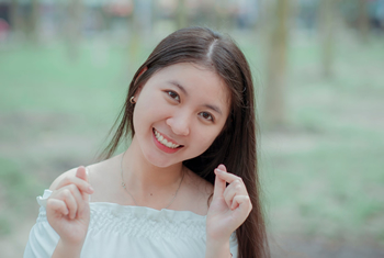 Asian looking woman smiling outdoor