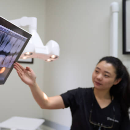 Dentist pointing to xray