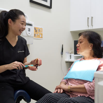 Dr Ying demonstrating oral care