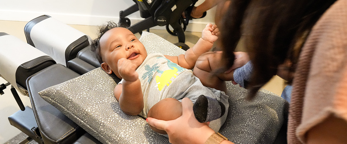 baby smiling at doctor