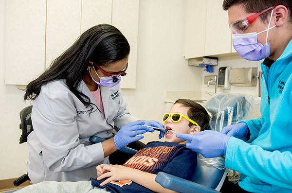 dentist examining child's mouth
