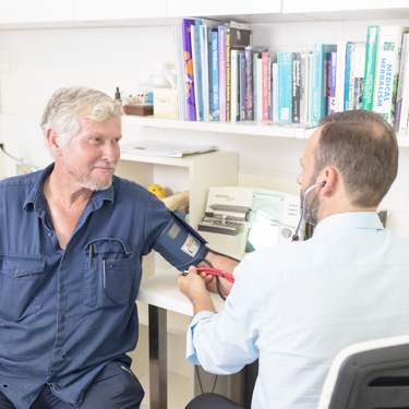 Stuart Morick taking a patient's blood pressure