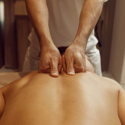 male-massage-therapist-massaging-persons-upper-back-sq
