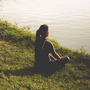 woman sitting and relaxing on grass