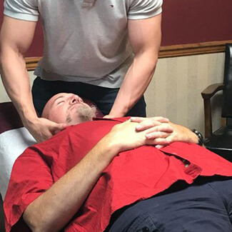 Dr. Chris performing Chiropractic adjustment