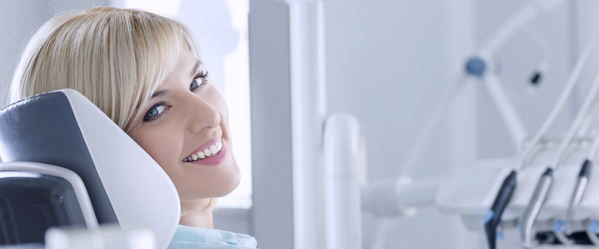 woman smiling over shoulder with white teeth