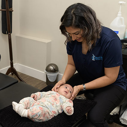 Chiropractor adjusting baby