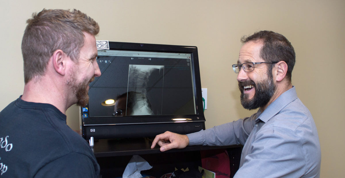 Chiropractor reviewing xray with patient