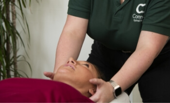 Connect Spinal Health patient having neck adjusted