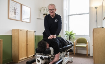 Connect Spinal Health patient laying on adjusting table